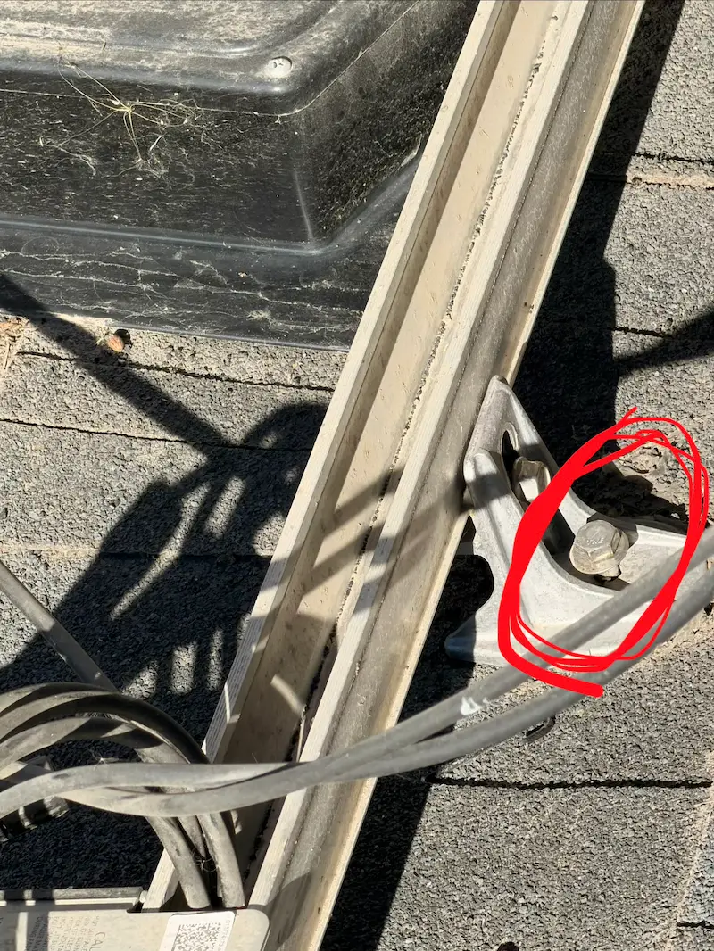 Lag bolt from solar panel bracket that caused a roof leak, circled in red