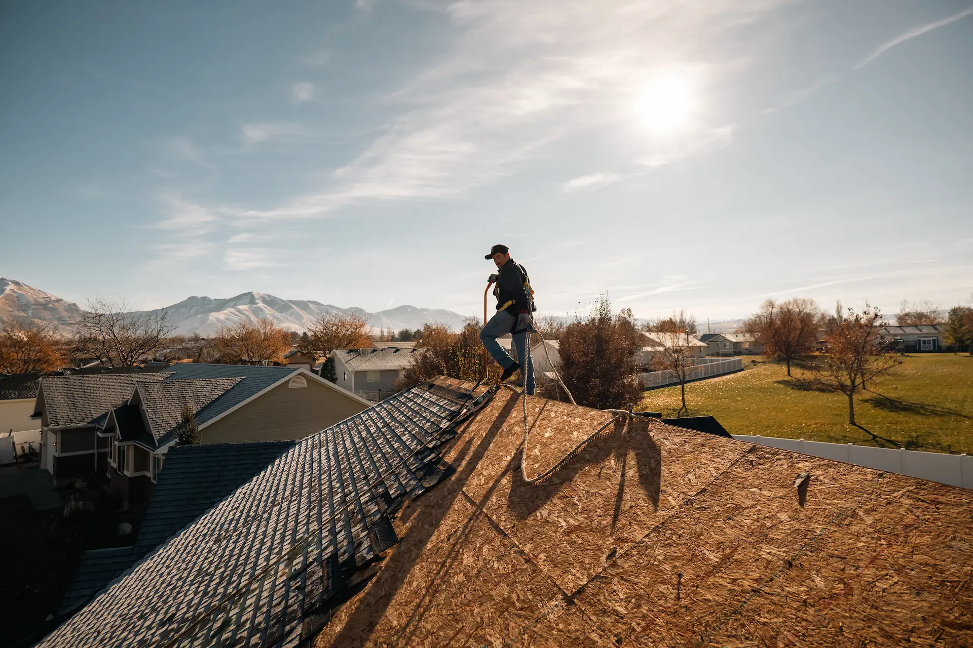 Homer Roofing crew installing GAF Timberline HDZ shingles over synthetic underlayment during a roof replacement in Northern Utah